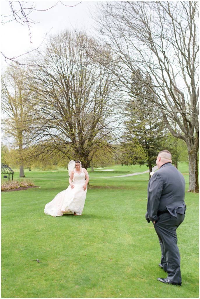bride and groom first look on golf course
