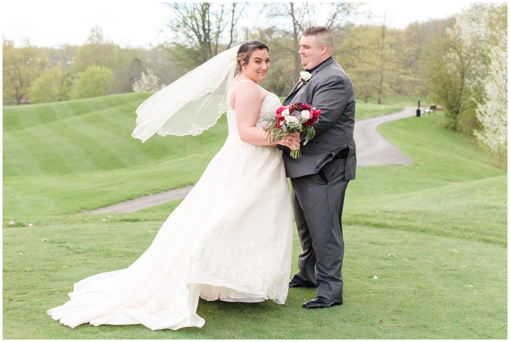 bride and groom portraits on golf course