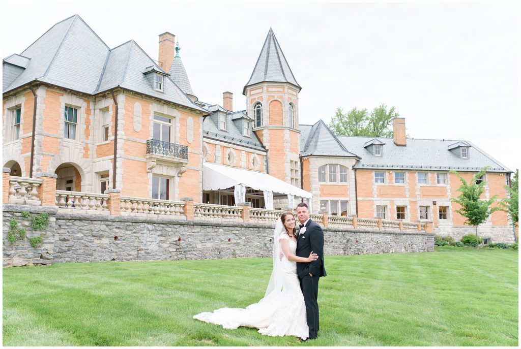 bride and groom in front of estate