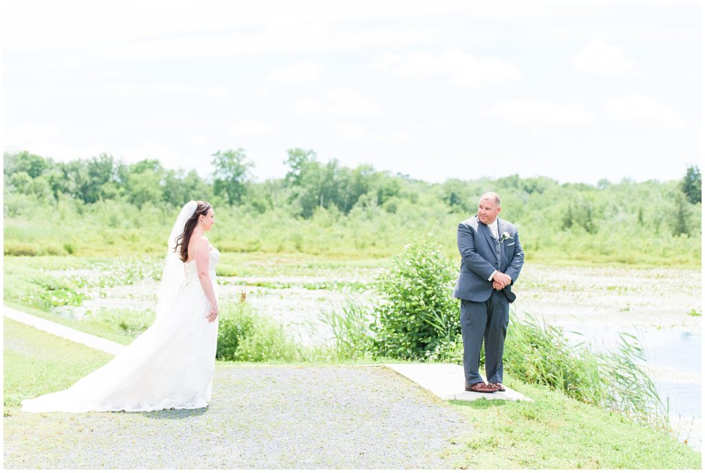 bride and groom first look on lake