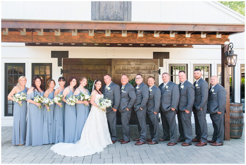 wedding party in front of barn