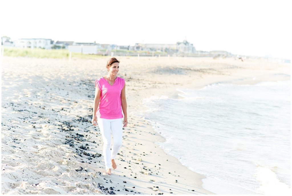 female entrepreneur walking by water on beach
