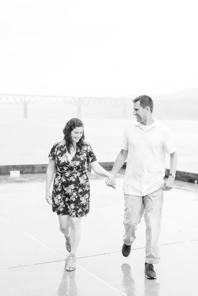 couple walking along water holding hands