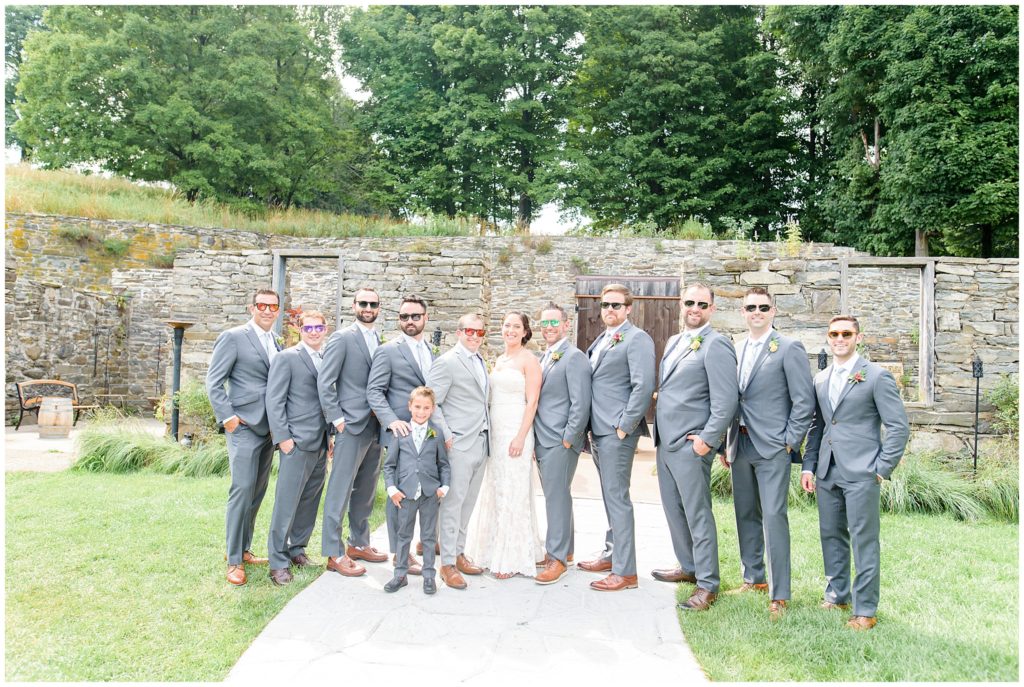 bridal party in front of stone wall
