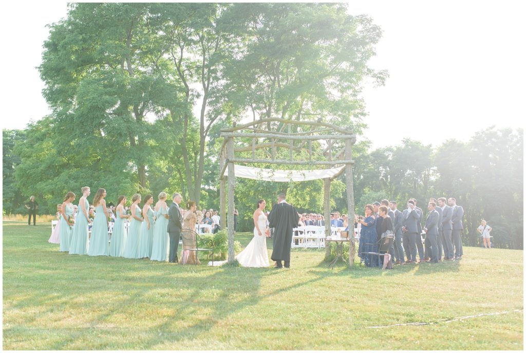 outdoor wedding ceremony under arch