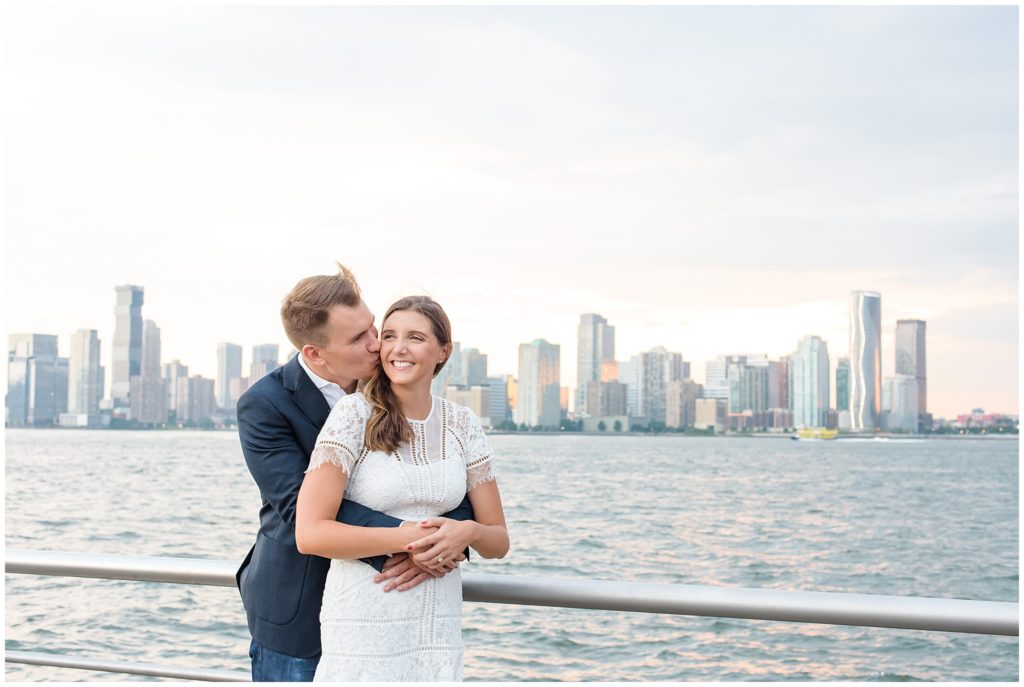 couple embracing with city skyline