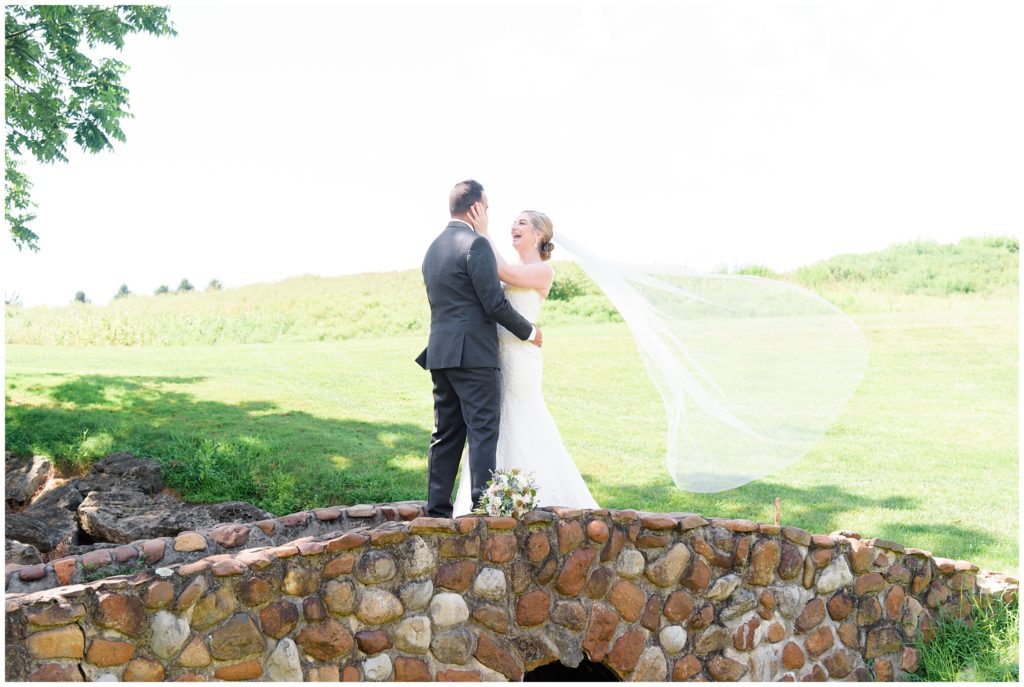 bride and groom first look on stone bridge