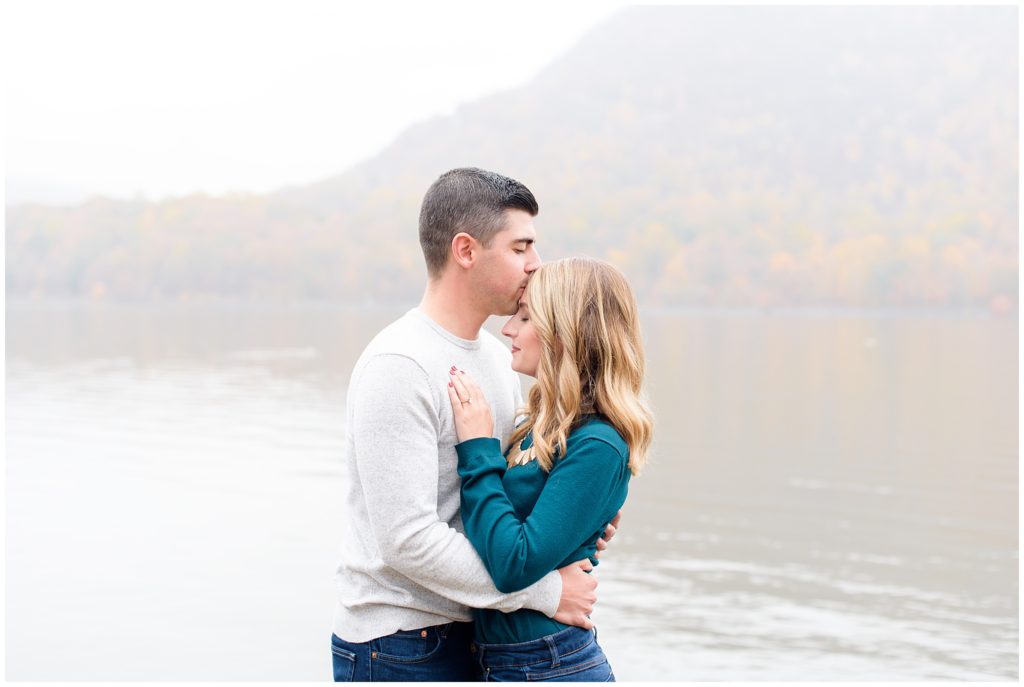 couple hug in front of foggy lake