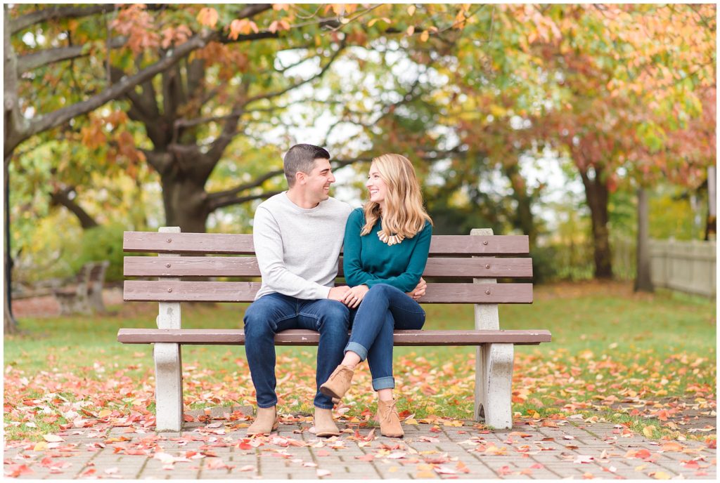 couple on bench with fall foliage